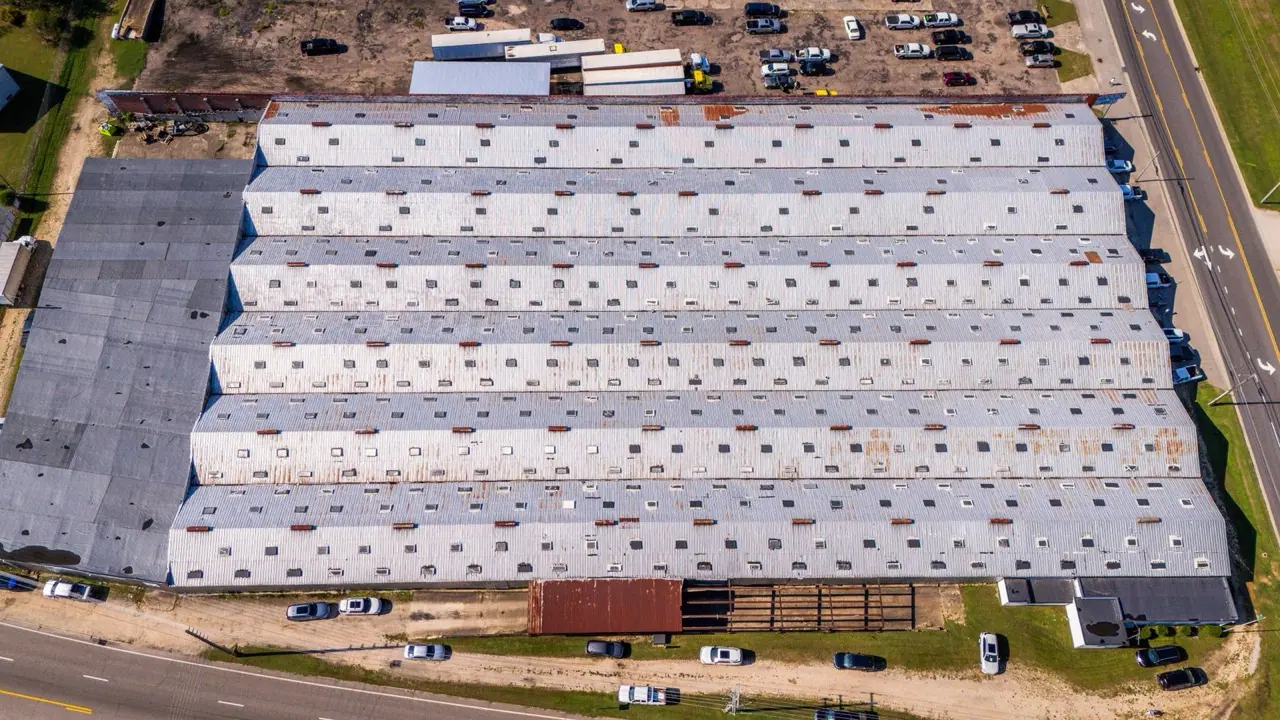 Aerial view of large low-slope industrial roofs